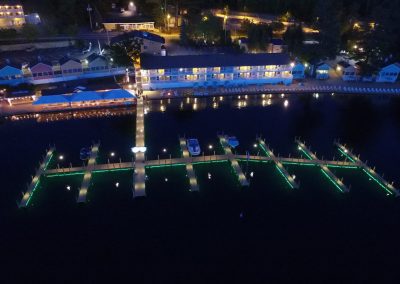 Aerial view of The NASWA Resort, docks and Lake Winnipesaukee at night