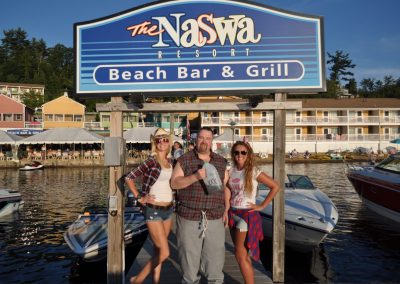 Friends posing under the NASWA Resort dock sign.