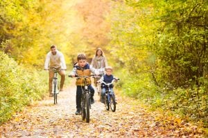 A family bikes down a trail at the White Mountains National Forest.